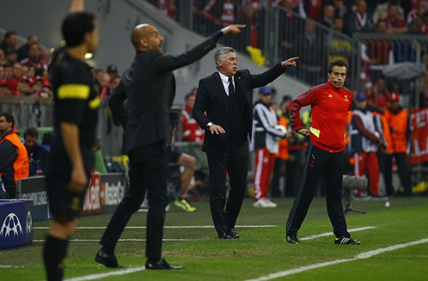 Bayern Munich's coach Guardiola and Real Madrid's coach Ancelotti  gesture to their players during Champion's League semi-final second leg soccer match in Munich