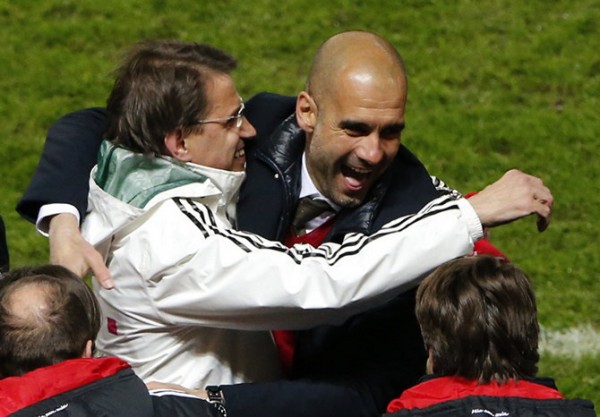 Bayern Munich's coach Guardiola celebrates winning Bundesliga title with Neuer after Bundesliga soccer match against Hertha Berlin in Berlin