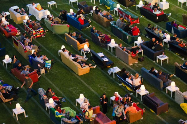 People sit on sofas as they watch the opening game of the 2014 World Cup between Brazil and Croatia, during a public viewing event in Berlin