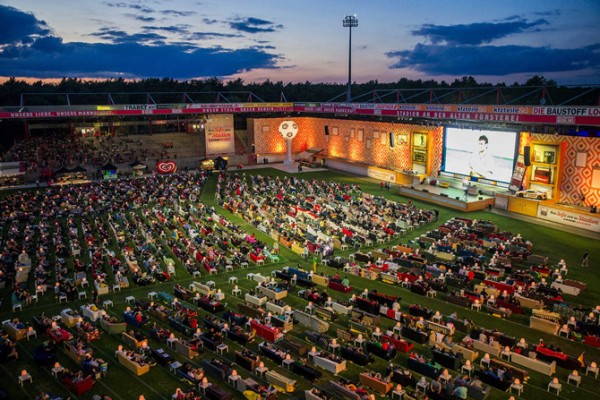 People sit on sofas as they watch the opening game of the 2014 World Cup between Brazil and Croatia, during a public viewing event in Berlin