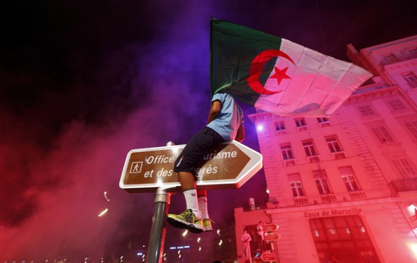 Algerian soccer fans celebrate after the end of Algeria's 2014 World Cup Group H match against Russia, in Marseille