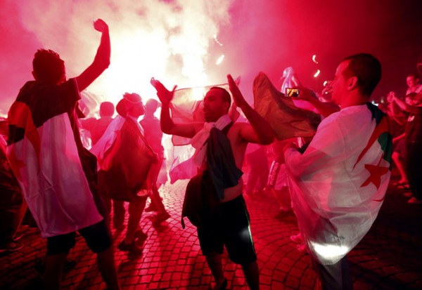 Algerian soccer fans celebrate after the end of Algeria's 2014 World Cup Group H match against Russia, in Marseille