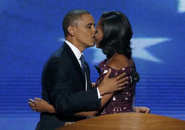 U.S. President Barack Obama kisses his wife, first lady Michelle Obama, as he arrives to address delegates during the final session of the Democratic National Convention in Charlotte