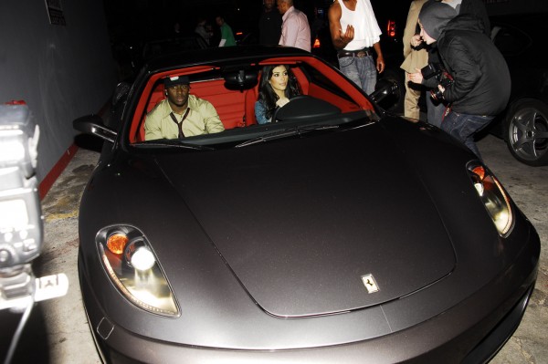 **CELEBRITY CARS** A rather sweaty Reggie Bush prepares to go for a ride with girlfriend Kim Kardashian in her Ferrari
