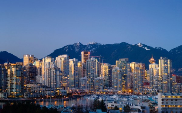 City skyline and north shore mountains at sunset Vancouver British Columbia Canada