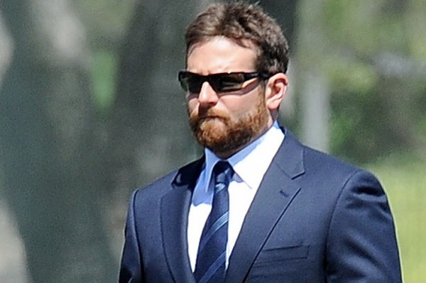 Actor Bradley Cooper puts on a suit for a funeral scene for his new movie "American Sniper" filming in Los Angeles. Bradley plays a role of a retired navy seal operative with co star Sienna Miller who was smoking up a storm during break at her trailer and