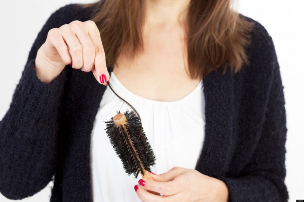 CC234H Caucasian woman cleaning her brush from her lost hair