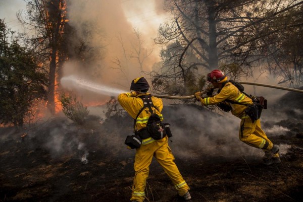 Firefighters race to battle a spot fire at the Rocky Fire in Lake County, July 30, 2015. REUTERS/Max Whittaker