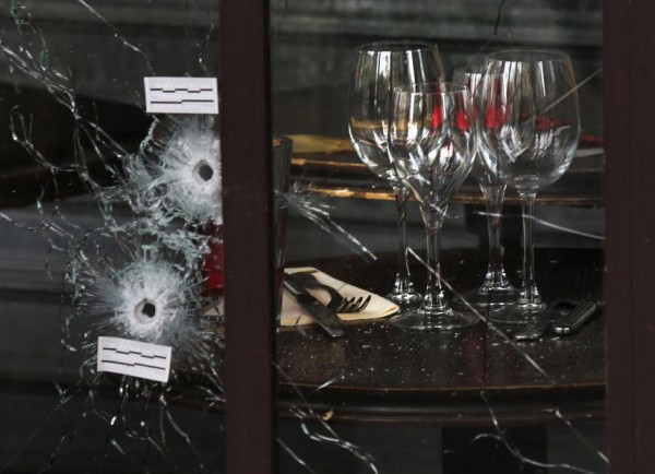 Bullet impacts are seen in the window of a restaurant window the day after a series of deadly attacks in Paris, November 14, 2015. REUTERS/Pascal Rossignol
