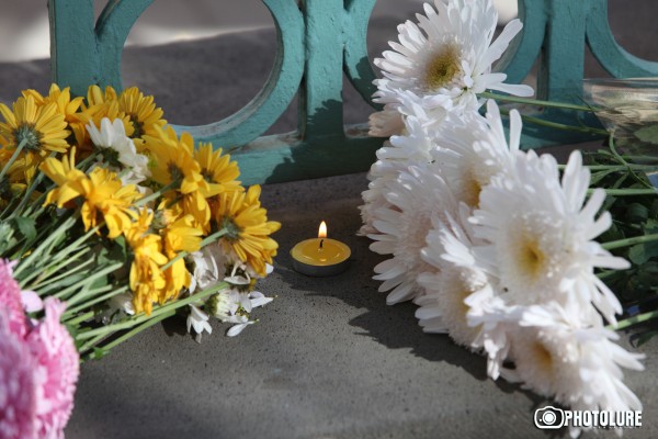 People put flowers in front of the French Embassy in Armenia in memory of the victims of terrorist attack in France