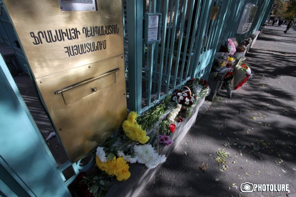 People put flowers in front of the French Embassy in Armenia in memory of the victims of terrorist attack in France