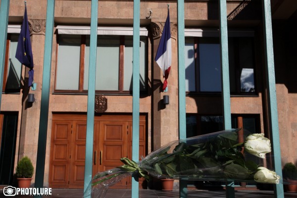 People put flowers in front of the French Embassy in Armenia in memory of the victims of terrorist attack in France