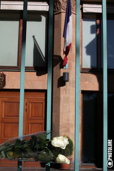 People put flowers in front of the French Embassy in Armenia in memory of the victims of terrorist attack in France