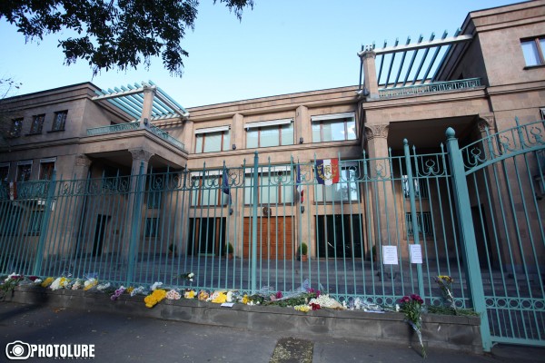 People put flowers in front of the French Embassy in Armenia in memory of the victims of terrorist attack in France