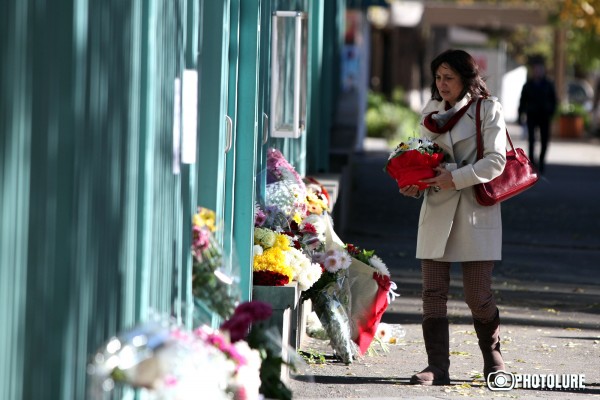 People put flowers in front of the French Embassy in Armenia in memory of the victims of terrorist attack in France