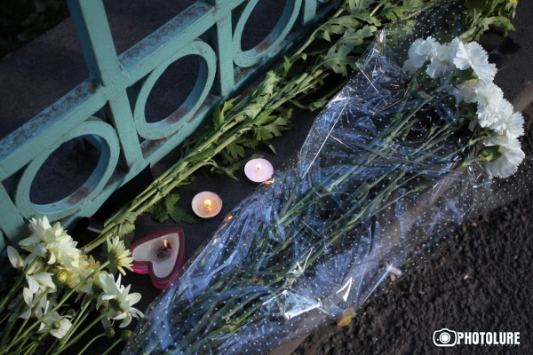 People put flowers in front of the French Embassy in Armenia in memory of the victims of terrorist attack in France