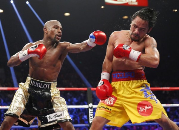 Floyd Mayweather, Jr. of the U.S. lands a left to the face of Manny Pacquiao of the Philippines in the 11th round during their welterweight WBO, WBC and WBA (Super) title fight in Las Vegas, May 2, 2015.  REUTERS/Steve Marcus