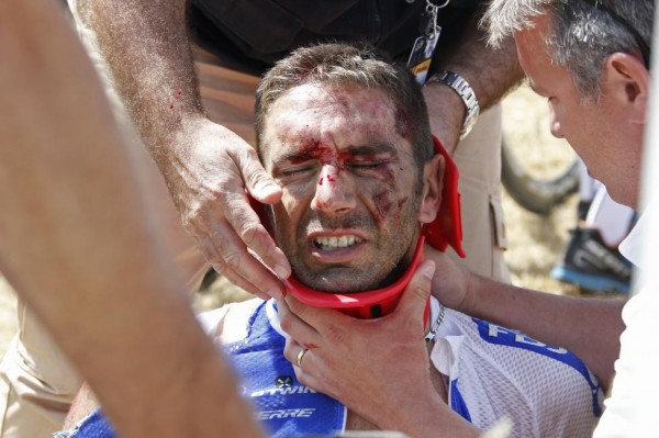 FDJ rider William Bonnet of France receives medical help as he sits on the ground after a fall during the 159,5 km (99 miles) third stage of the 102nd Tour de France cycling race from Anvers to Huy, Belgium, July 6, 2015.  REUTERS/Eric Gaillard
