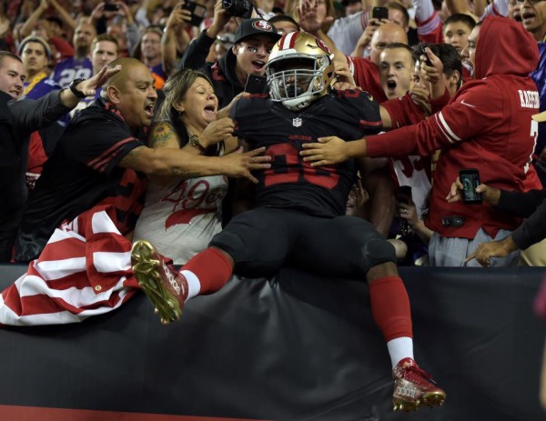 San Francisco 49ers running back Carlos Hyde celebrates with fans after scoring on a 10-yard touchdown run against the Minnesota Vikings in Santa Clara, September 14, 2015.  Kirby Lee-USA TODAY Sports