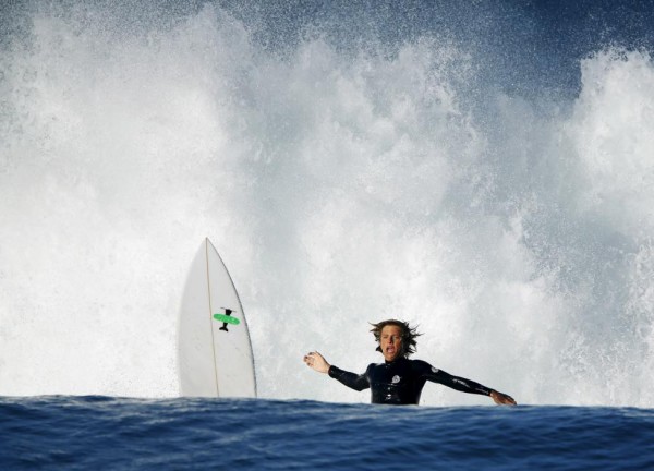 A surfer wipes out while trying to ride a breaking wave during high tide and high surf in Cardiff, California October 27, 2015. REUTERS/Mike Blake