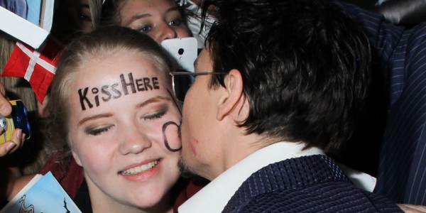 Johnny Depp kisses a fan at the red carpet premiere of 'Transcendence' at the Regency Village Theater in Los Angeles, CA. A young fan with a circle on her cheek and the words "Kiss Here" gets a kiss on the cheek from her idol Johnny Depp. Pictured: Johnny Depp Ref: SPL733224  100414   Picture by: London Ent / Splash News Splash News and Pictures Los Angeles:	310-821-2666 New York:	212-619-2666 London:	870-934-2666 photodesk@splashnews.com 