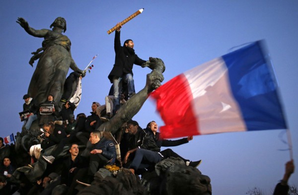 A man holds a giant pencil as he takes part in a Hundreds of thousands of French citizens solidarity march (Marche Republicaine) in the streets of Paris