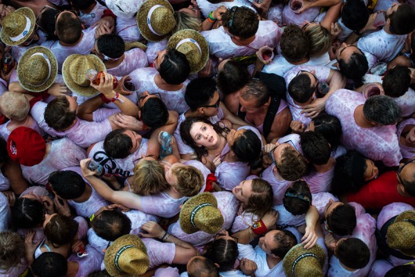 PAMPLONA, SPAIN - JULY 06:  Revellers enjoy the atmosphere during the opening day or 'Chupinazo' of the San Fermin Running of the Bulls fiesta on July 6, 2015 in Pamplona, Spain. The annual Fiesta de San Fermin, made famous by the 1926 novel of US writer Ernest Hemmingway entitled 'The Sun Also Rises', involves the daily running of the bulls through the historic heart of Pamplona to the bull ring.  (Photo by David Ramos/Getty Images)