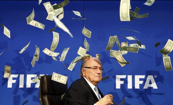 British comedian known as Lee Nelson (unseen) throws banknotes at FIFA President Sepp Blatter as he arrives for a news conference after the Extraordinary FIFA Executive Committee Meeting at the FIFA headquarters in Zurich, Switzerland July 20, 2015. World football's troubled governing body FIFA will vote for a new president, to replace Sepp Blatter, at a special congress to be held on February 26 in Zurich, the organisation said on Monday.       REUTERS/Arnd Wiegmann  - RTX1L1PD