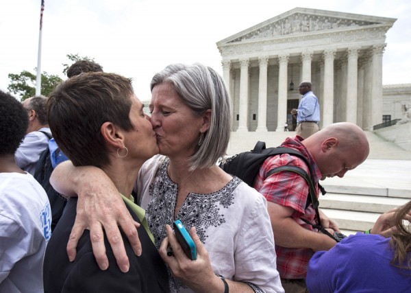 Rea Carey (L) kisses her wife Margaret Conway after the U.S. Supreme Court ruled on Friday that the U.S. Constitution provides same-sex couples the right to marry at the Supreme Court in Washington June 26, 2015.     REUTERS/Joshua Roberts - RTX1HXIP