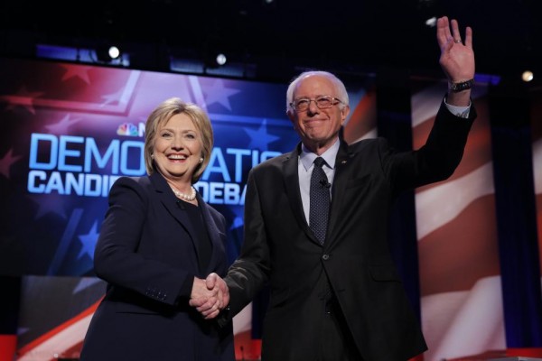 Hillary Clinton and Bernie Sanders shake hands before the start. REUTERS/Carlo Allegri