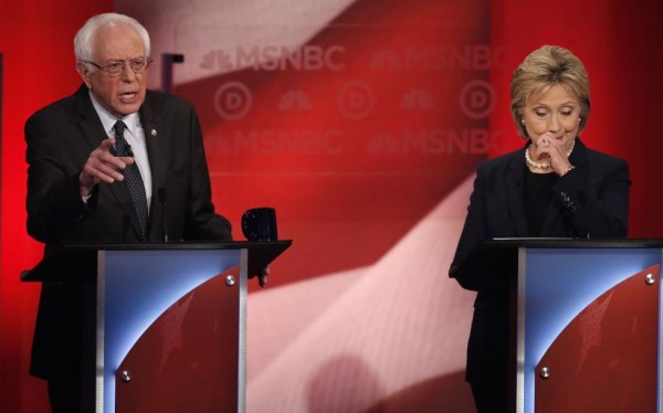 Hillary Clinton reacts as Bernie Sanders speaks. REUTERS/Mike Segar