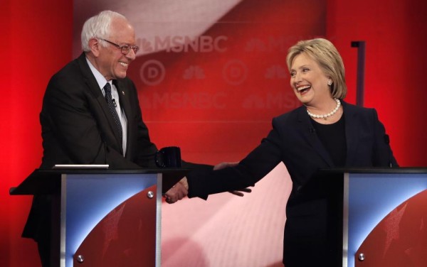 Bernie Sanders and Hillary Clinton shake hands in the midst of the debate. REUTERS/Mike Segar