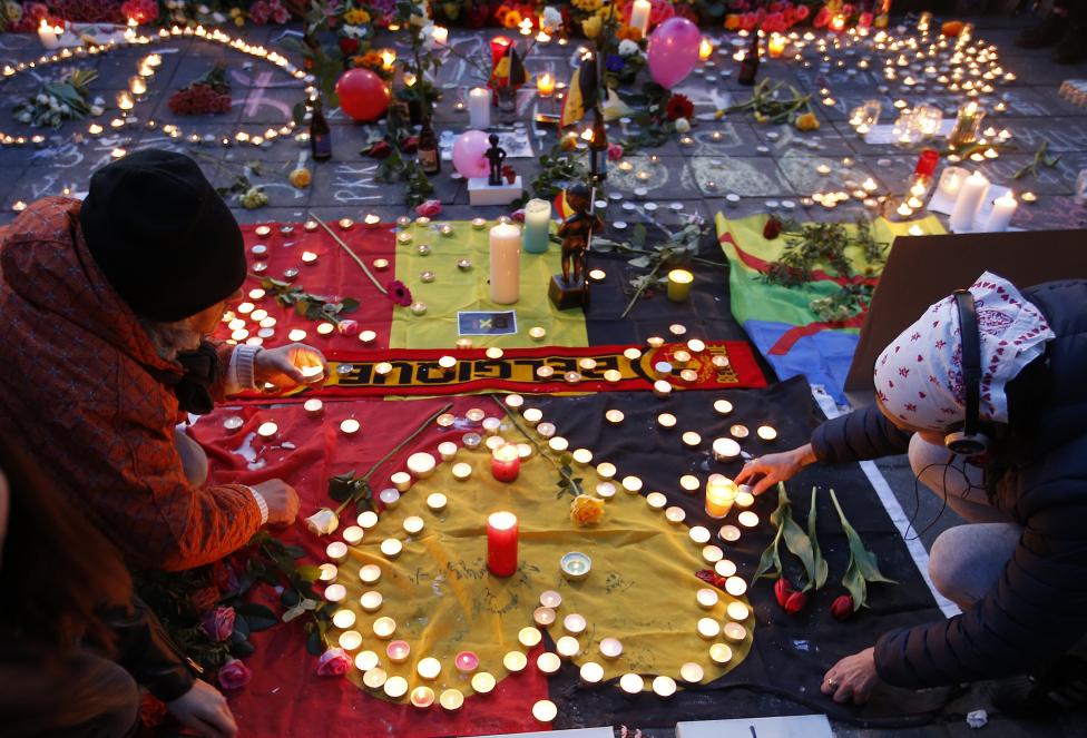 People gather around a memorial in Brussels following bomb attacks in Brussels, Belgium, March 22, 2016. REUTERS/Charles Platiau