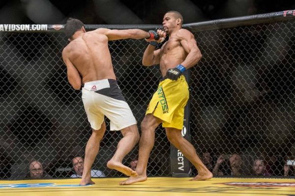 Jul 9, 2016; Las Vegas, NV, USA; Thiago Santos (blue gloves) blocks Gegard Mousasi (red gloves) during UFC 200 at T-Mobile Arena. Mandatory Credit: Joshua Dahl-USA TODAY Sports