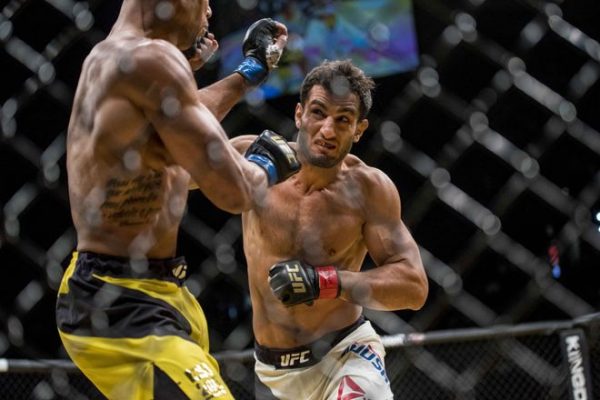 Jul 9, 2016; Las Vegas, NV, USA; Thiago Santos (blue gloves) gets punched by Gegard Mousasi (red gloves) during UFC 200 at T-Mobile Arena. Mandatory Credit: Joshua Dahl-USA TODAY Sports