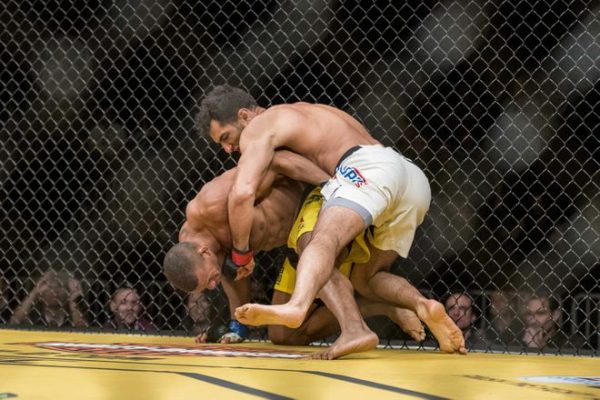 Jul 9, 2016; Las Vegas, NV, USA; Thiago Santos (blue gloves) gets punched by Gegard Mousasi (red gloves) during UFC 200 at T-Mobile Arena. Mandatory Credit: Joshua Dahl-USA TODAY Sports