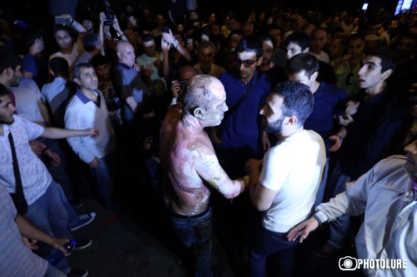 On the 14th day of the occupation of Patrol-Guard Service Regiment of Erebuni district by 'Sasna Tsrer' group, protesting people marched to Baghramyan Avenue in Yerevan, Armenia. One of the protesters set himself on fire