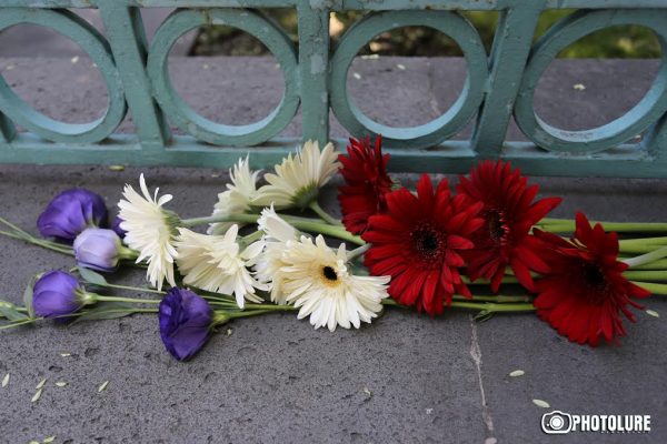 People put flowers in front of the French Embassy in Armenia in memory of the victims of terrorist attack in Nice, France
