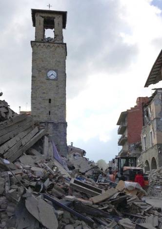 The partially damaged tower bell with the clock signing the time of the earthquake is seen in Amatrice, central Italy, August 24, 2016. REUTERS/Emiliano Grillotti