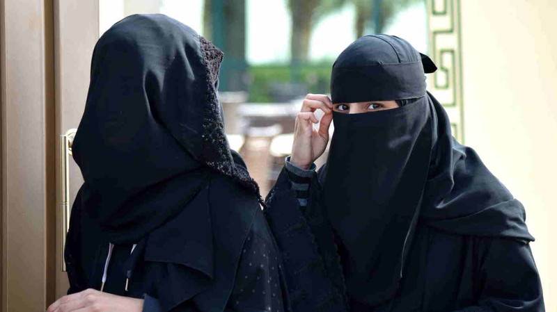 Women walk out of a polling station after casting their votes for municipal elections in Riyadh, Saudi Arabia, on Saturday.