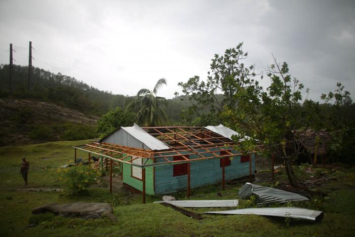 Farmer Nicolas Maturel, 27, stands next to his damaged house after the passage of Hurricane Matthew in Carbonera, Cuba, October 5, 2016. REUTERS/Alexandre Meneghini