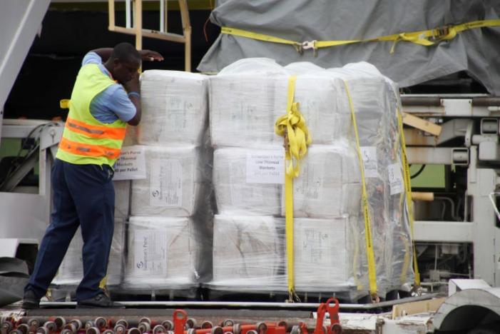 A worker loads a tarmac trolley with relief aid donated by Samaritan's Purse International Relief at the airport in Port-au-Prince, Haiti, October 6, 2016. REUTERS/Jeanty Junior Augustin