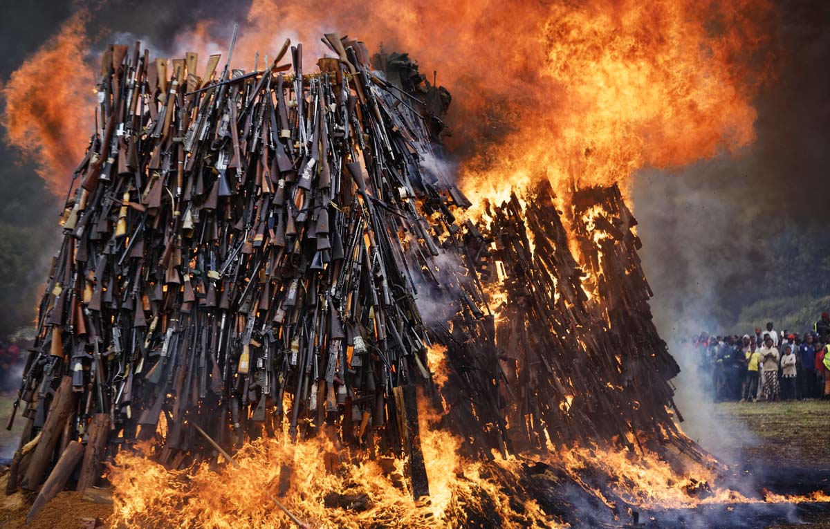 A pile of 5,250 illegal weapons are burned by Kenyan police in Ngong, near Nairobi, in Kenya Tuesday, Nov. 15, 2016. The weapons consisted of both confiscated and surrendered firearms that had been stockpiled over almost a decade and were destroyed by police as a message to the public to surrender others. (AP Photo/Ben Curtis)