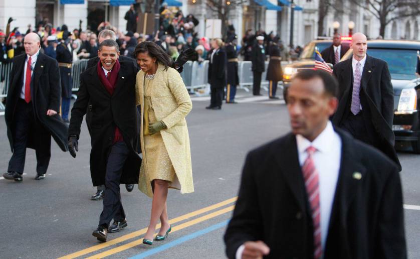 U.S. Secret Service agents walk alongside President Barack Obama and first lady Michelle Obama as they wave to crowds along the inaugural parade route in Washington, Tuesday, Jan. 20, 2009. (AP Photo/Charles Dharapak)